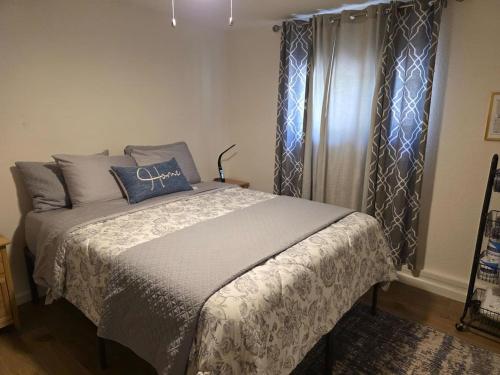 a bedroom with a bed and a window with curtains at Modern Victorian by Beach and Forest Unit D in Crescent City