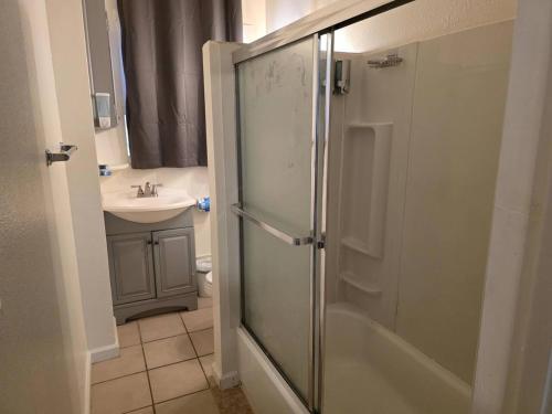a bathroom with a shower and a sink at Modern Victorian by Beach and Forest Unit D in Crescent City