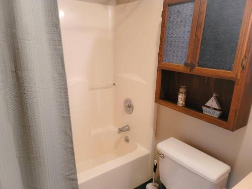 a bathroom with a toilet and a shower with a window at The Hofer Beach Retreat in Crescent City