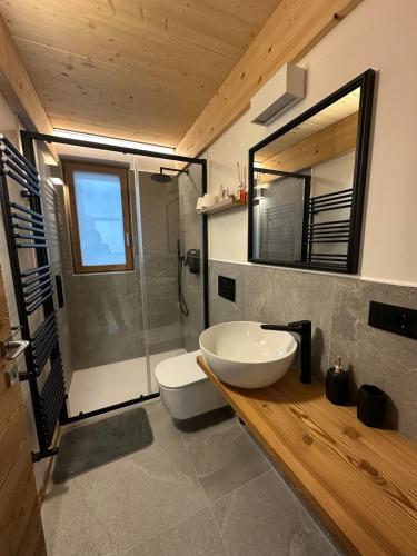 a bathroom with a white sink and a shower at Maison ValGià in Champoluc