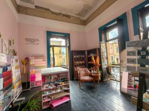 a room with a book store with a chair and a table at Villa Catrina in Morelia