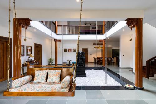 a living room with a couch in the middle at 1st Miracle By Mirth, Mythadi , Coorg in Ammatti