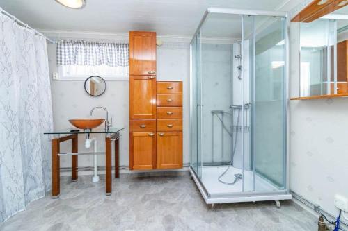 a bathroom with a shower and a table and a sink at VAR986-Rada-As-34 in Råda