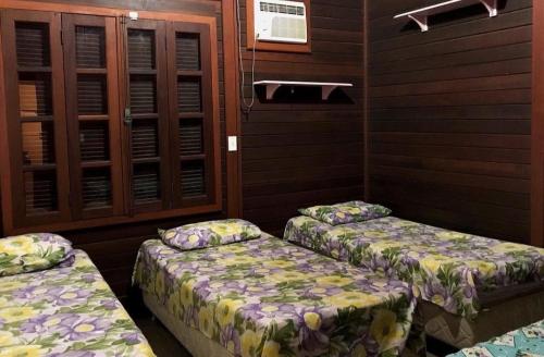 a room with two beds in a room at Casa Da MAELA in Corumbau