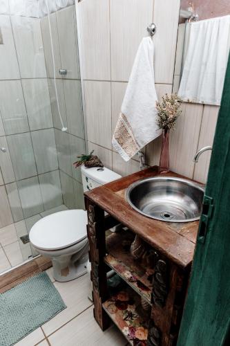 a bathroom with a sink and a toilet and a shower at Country house, peace comfort & love in Contagem