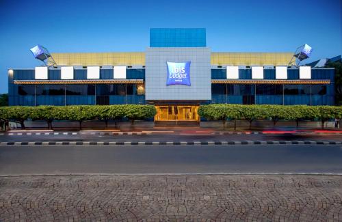a building with a sign on the side of it at Ibis Budget Jakarta Menteng in Jakarta