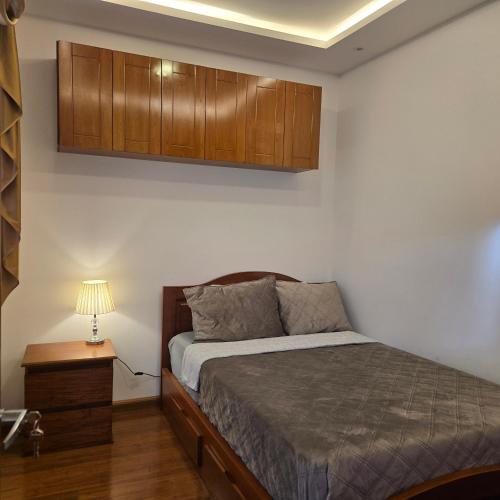 a bedroom with a bed and wooden cabinets at majesty beautiful suite in Cuenca