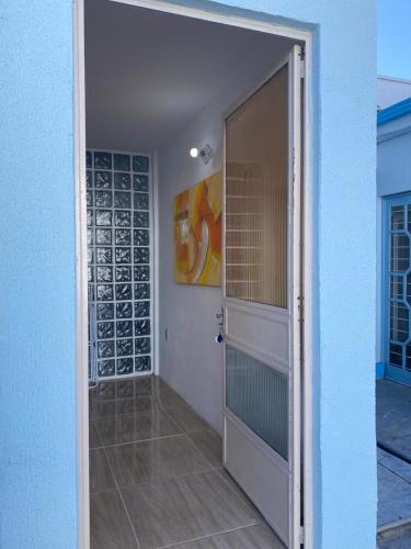 a door leading into a room with a building at Apartamento central próximo à catedral com 2 quartos e 2 banheiros in Santo Ângelo