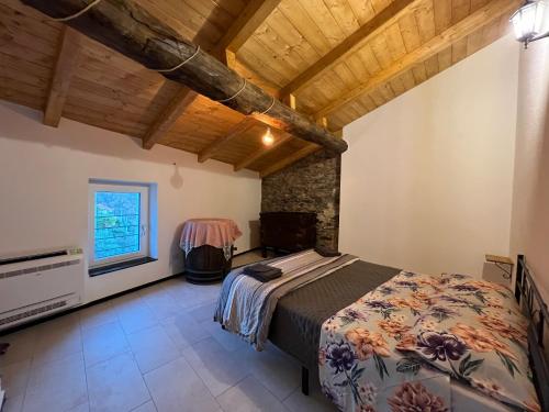 a bedroom with a large bed and a window at La Dimora Della Volpe in Calice Ligure