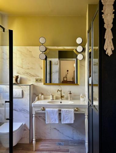 a bathroom with a sink and a mirror at Beach House Labineca in Gradac