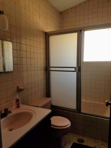a bathroom with a sink and a toilet and a sink at Casa Amari - Para 17 Personas - Grupos y Eventos in Morelia