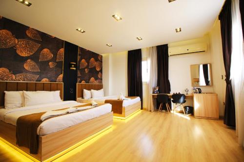 a hotel room with a bed and a desk at Palm Pyramids View INN in Cairo