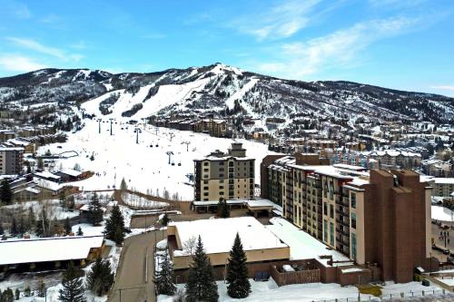 a city with a snow covered mountain in the background at Sheraton Steamboat Resort Villas in Steamboat Springs