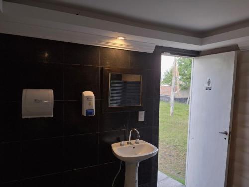 a bathroom with a sink and a window at Oasis Pueyrredón in Rodeo del Medio