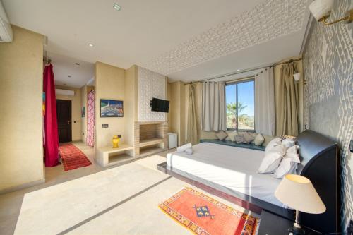 a bedroom with a large bed and a large window at Villa Maloulou in Marrakesh