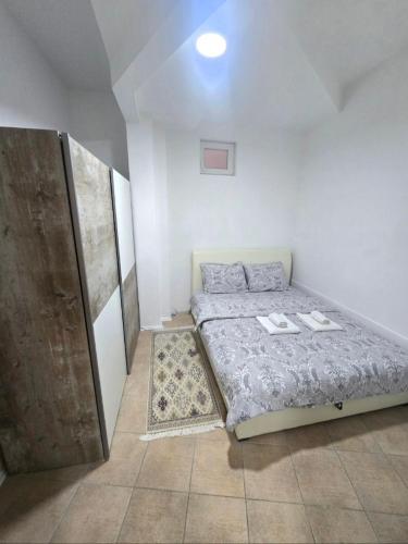 a small bedroom with a bed and a door at Iskra Apartment 2 in Kragujevac