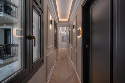 a hallway with doors and windows in a house at Mountain Pine Luxury Suites in Florina