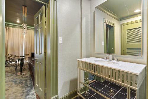 a bathroom with a sink and a mirror at Chic Dallas Retreat Trail, Soaking Tub & Patio in Dallas