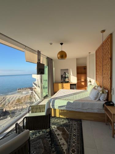 a bedroom with a large bed and a large window at Sky rooftop luxury suites in Durrës