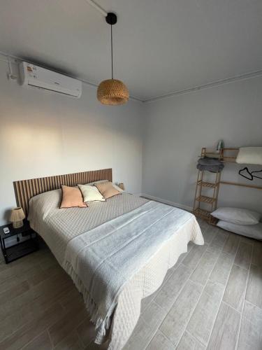 a bedroom with a large bed with pink pillows at La casa de Tokyo in Carmelo