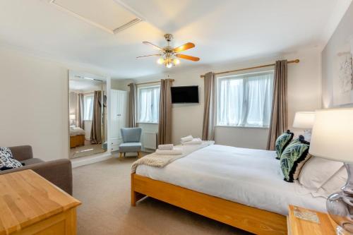 a bedroom with a large bed with a ceiling fan at 2 Bed in Bamburgh oc-gd1273 in Bamburgh