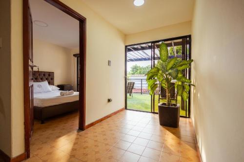 a hallway with a room with a bed and a plant at Casa Lilí Guaduas in Guaduas