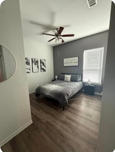 a bedroom with a bed and a ceiling fan at Beautiful modern 3 bed 2 bath in Fort Worth