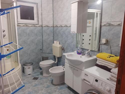 a bathroom with a sink and a toilet and a shower at Apartman Leki in Sarajevo