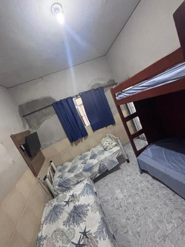 a room with two bunk beds and a window at Pousada Mara Mar Niterói in Niterói