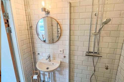 a bathroom with a sink and a shower at Valle vandrarhem och camping in Axvall