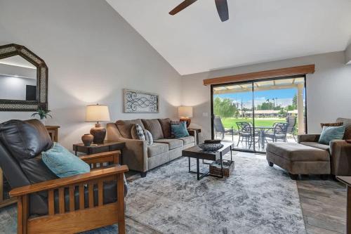a living room with a couch and a table at PL645 - Bay Hill Fairway - Alice Lodging in Palm Desert