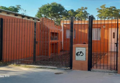 an orange fence with a price sign on it at Dpto en San Antonio Oeste 3 pax in San Antonio Oeste