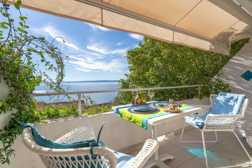 a patio with a table and chairs and the ocean at Libera1 in Stara Baška