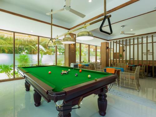 a pool table in the middle of a room at Plumeria Maldives in Thinadhoo