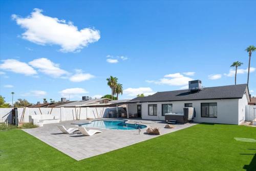 a backyard with a pool and a house at Rock and Glam Paradise in Mesa