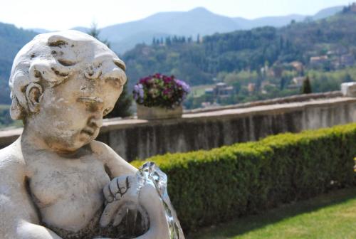 a statue of a little boy holding a ball at Palazzo Leti Residenza d'Epoca in Spoleto