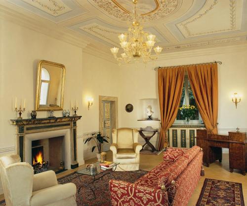 a living room with a couch and a fireplace at Palazzo Leti Residenza d'Epoca in Spoleto