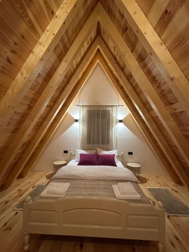 a bedroom with a large bed in the attic at Vila Ramonda in Žabljak