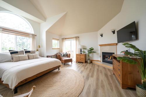 a bedroom with a large bed and a fireplace at Tolovana 6 in Cannon Beach