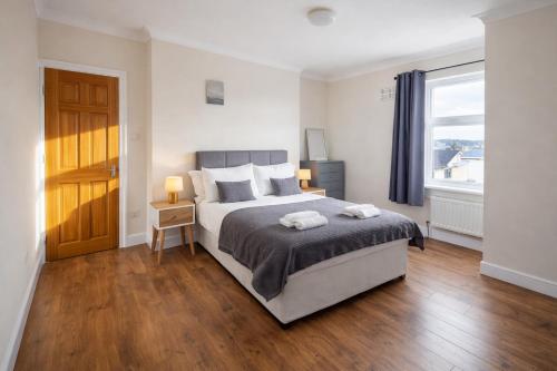 a bedroom with a large bed and a window at Evo C - 2 Bed Apartment 2 Min Walk to Station - longer stays available in Gravesend