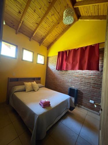 a bedroom with a bed and a red window at Los Pinos in El Bolsón