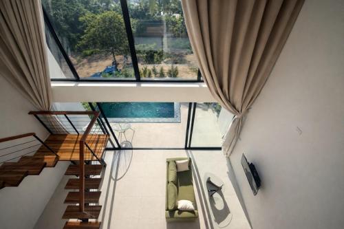 a room with stairs and a large window at Sumba Luxury Pool Cottages in Ko Phangan