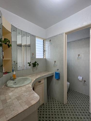 a bathroom with a sink and a toilet at Bobby's Villa Beachfront, Paringao, La Union in Bauang