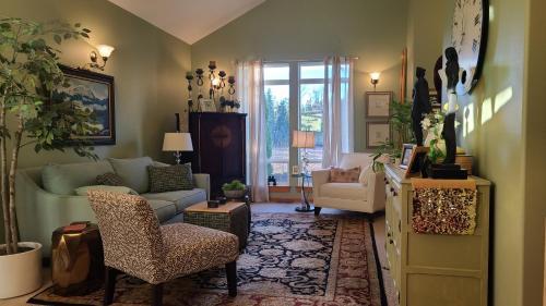 a living room with a couch and a chair at Mt Rainier Way Bedroom with Private Full Bath in Eatonville