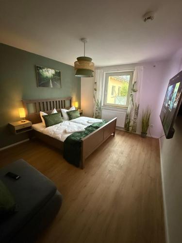 a bedroom with a large bed and a window at Mete Stays - Modern - Workspace - Cool location in Ingolstadt
