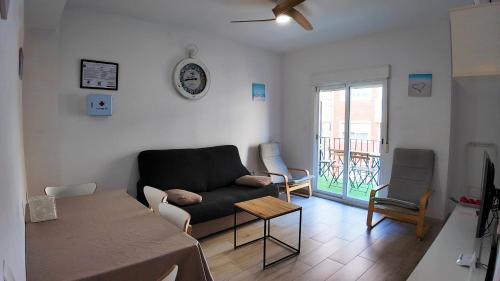 a living room with a couch and a table at Apartalux Benidorm's Port in Benidorm
