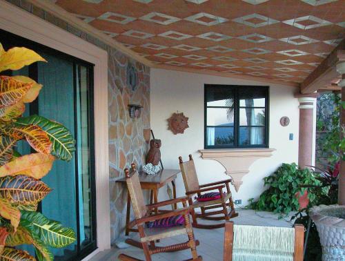 a patio with chairs and a table on a porch at La Valise Los Cabos in Boca de la Vinorama