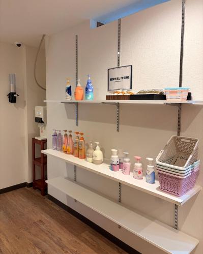 a shelf filled with lots of different colored bottles at hotel LUNA STELLA in Sendai