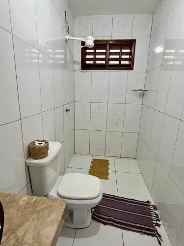 a white bathroom with a toilet and a window at Casa Flor e Ser Rua Onezinda da Costa Barros ,80 in Parnaíba