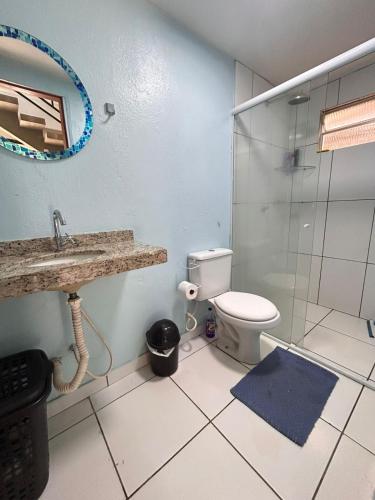 a bathroom with a toilet and a glass shower at Casa Lima in Imperatriz